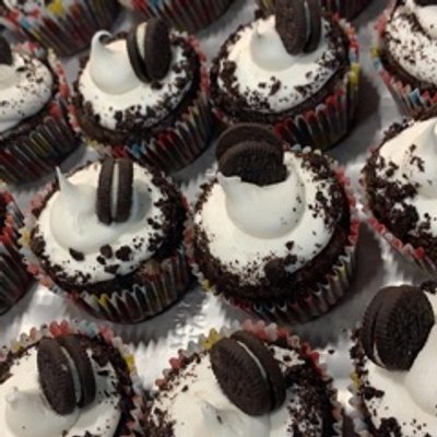 Cookies And Cream- Chocolate cake filled with Oreo chunks, topped with a marshmallow frosting and mini Oreo cookie!