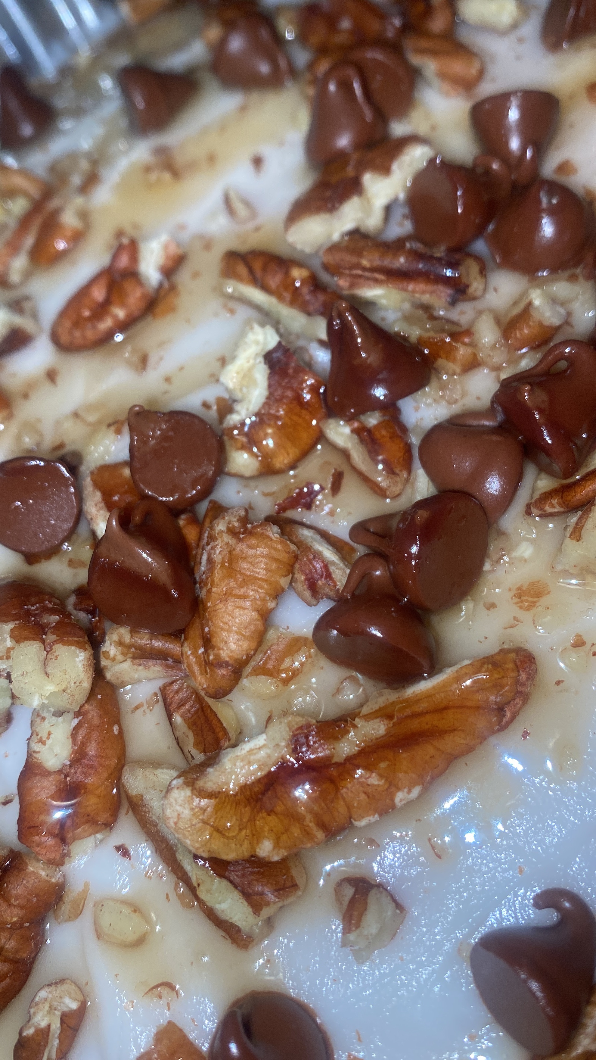 Almond Cake w/ Buttercream Frosting Topped With Chocolate Chips Pecans Caramel Sauce