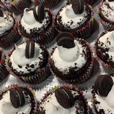 Cookies And Cream- Chocolate cake filled with Oreo chunks, topped with a marshmallow frosting and mini Oreo cookie!