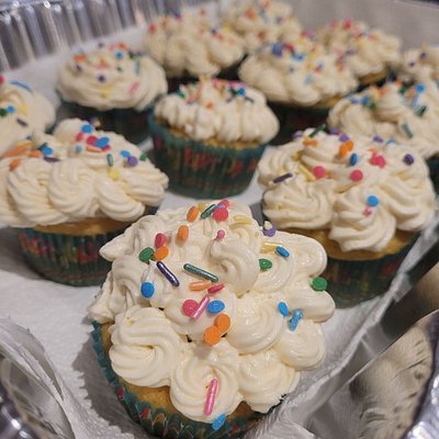 1 Dozen Vanilla Cupcakes Topped With Vanilla Swiss Buttercream Adorned With Sprinkles