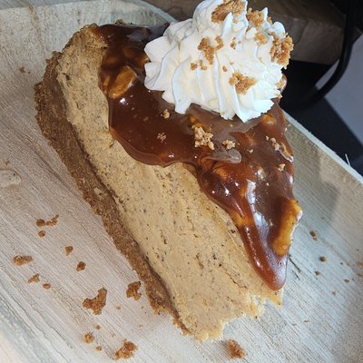 Slice Of Vanilla Bean Cheesecake with Pecan Praline Sauce
