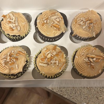Devils food Cupcake With Peanut Butter Buttercream Frosting Caramel Drizzle And Pretzels 