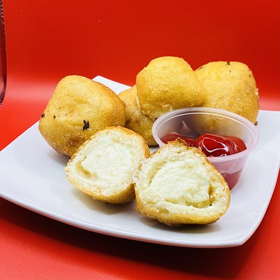 Fried Cheesecake Bites Drizzled In Strawberry
