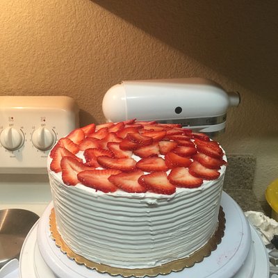 Vanilla cake with strawberry filling, and fresh strawberries topping